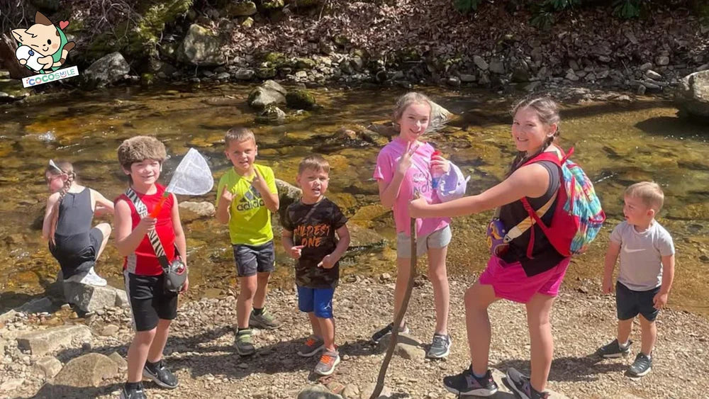 Children playing outdoors in summer with Cocosmile Cup water bottles, highlighting hydration tips for active kids