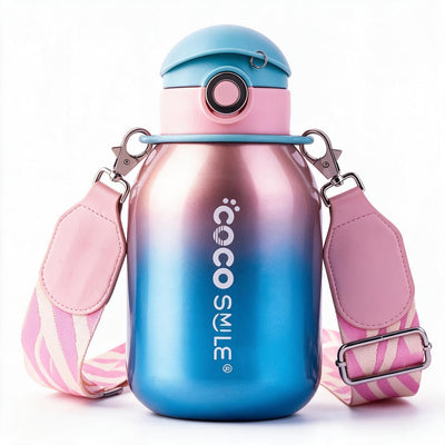 A Cocosmile water bottle with a metallic blue-to-pink gradient body, a light blue and pink lid, and a pink patterned shoulder strap with silver metal clips, shown on a white background.