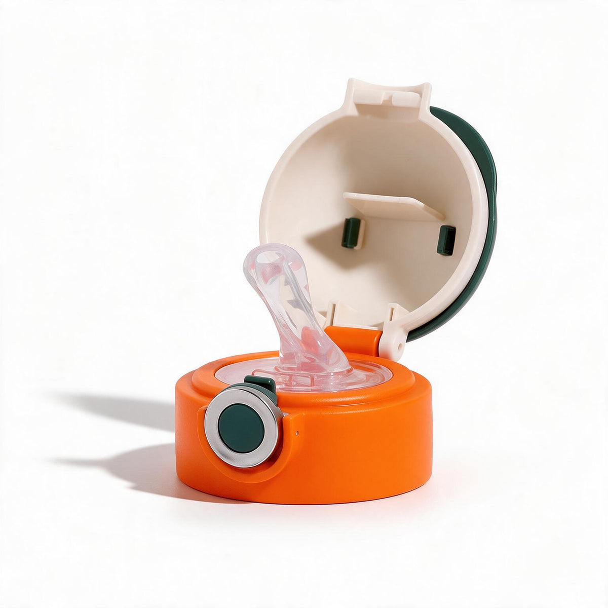An orange and cream baby bottle accessory set featuring a clear silicone nipple on a round orange base with a dark green accent, shown with its matching cream and dark green lid open against a white background.