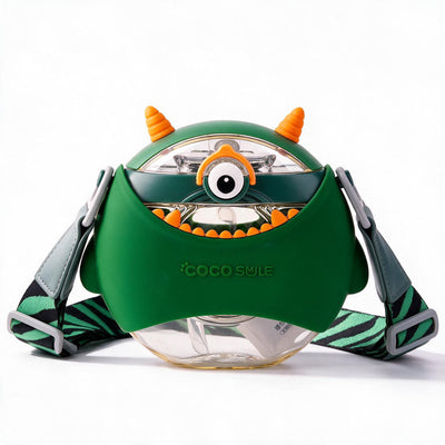 A green monster-themed water bottle with orange horns, a large cartoon eye, and a patterned strap, photographed on a clean white background.